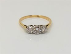 An 18ct gold three stone diamond ring, size P CONDITION REPORT: 2.