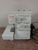 A Janome 204D overlocking sewing machine with foot pedal