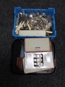 A tray and basket containing boxed and unboxed stainless steel and plated cutlery