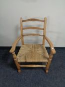 An early twentieth century beech rush seated armchair