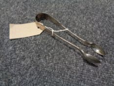 A pair of antique silver sugar tongs