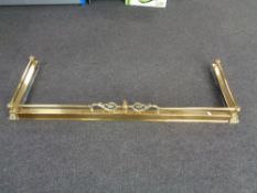 An antique brass telescopic fire curb