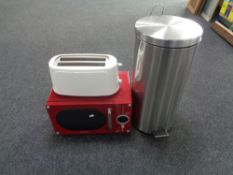 A Daewoo microwave together with a toaster and a pedal bin