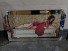 A contemporary framed print of a lady in red dress reclining on a grand piano,
