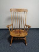 A beech spindle back rocking chair