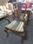 A mahogany scroll armchair on cabriole legs