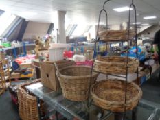A metal and wicker three tier stand with four further wicker baskets