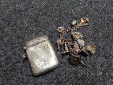 A vintage white metal charm bracelet together with a silver plated vesta case