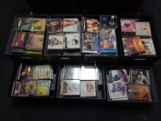 Seven contemporary lidded leather storage boxes containing various CDs