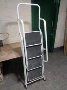 A set of folding four rung metal steps
