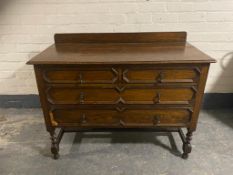 An Edwardian oak four drawer chest on barley twist legs