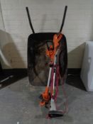 A metal wheelbarrow,