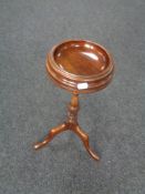 A mahogany smoker's stand on three way pedestal
