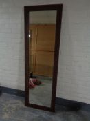 A copper-effect framed hall mirror