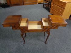 A mid twentieth century concertina sewing box on cabriole legs