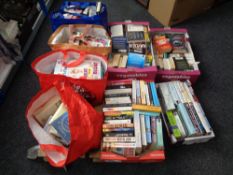 Four boxes and four bags containing hard back and paper back books,