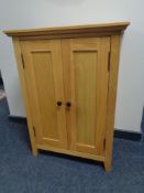 A contemporary oak double door cabinet, 65 x 40 x 90 cm.