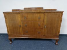 An Edwardian mahogany sideboard on claw and ball feet.