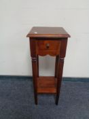 An Indonesian hardwood plant stand fitted to drawer with under shelf.