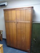 An Austin suite oak double door wardrobe.