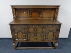 An Edwardian carved oak buffet back sideboard.