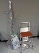 A folding metal clothes rail with shelf,