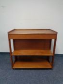 A mid 20th century teak tea trolley.