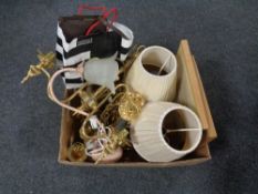A box containing framed prints, leather bag, brass table lamps with shades,