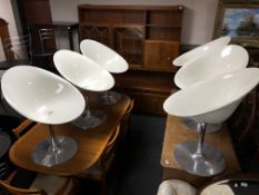 A set of six Philippe Starck for Kartell Italian swivel Eros tub chairs on metal pedestals.