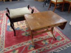 An Edwardian storage piano stool containing sheet music together with a flap sided sofa table