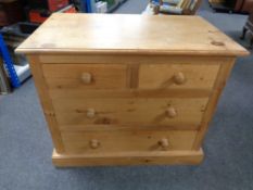 A pine four drawer chest.