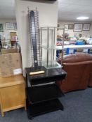 A black ash computer trolley together with a metal and glass three tier stand and a CD stand.