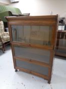 An early 20th century oak three piece sectional bookcase