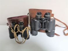 Two sets of early twentieth century leather cased field glasses.