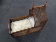 An antique mahogany and bergere cot.