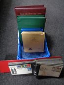 A quantity of First Day covers and albums containing stamps.