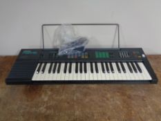 A Yamaha PSR-16 electric keyboard with lead.