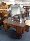 A 20th century Queen Anne kneehole dressing table fitted with seven drawers, with triple mirror.