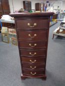 A Georgian style serpentine fronted narrow seven drawer chest.
