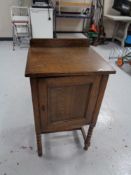 An Edwardian oak pot cupboard on bobbin legs.