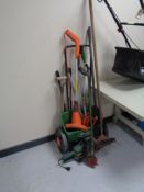 A quantity of assorted gardening tools together with an electric strimmer and a Black & Decker