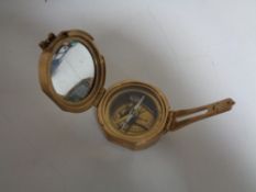 A brass cased nautical compass.