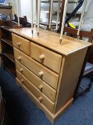 A stripped pine five drawer chest.