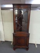 A mahogany corner display cabinet fitted with cupboards beneath