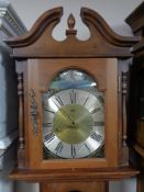 A Brixon Tempus Fugit longcase clock with pendulum and weights.