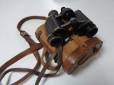 A pair of antique Helinox German binoculars in a fitted leather case.