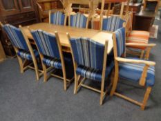 A blonde oak refectory dining table on X frame support,