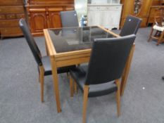 A contemporary Calligaris glass topped extending dining table together with a set of four black