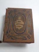 A 19th century leather bound family bible containing colour book plates.