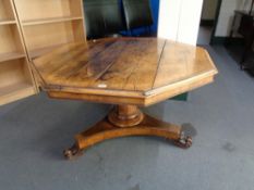 A 19th century octagonal oak tilt topped pedestal table.